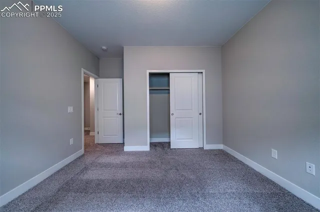 an empty room with closet area