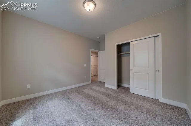 an empty room with closet area