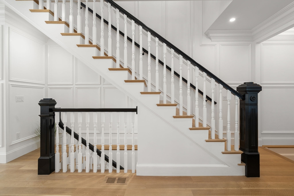 32 High Street Boston, MA 02129 - Photo 12 of 38 a view of staircase with lots of frames on wall and wooden floor