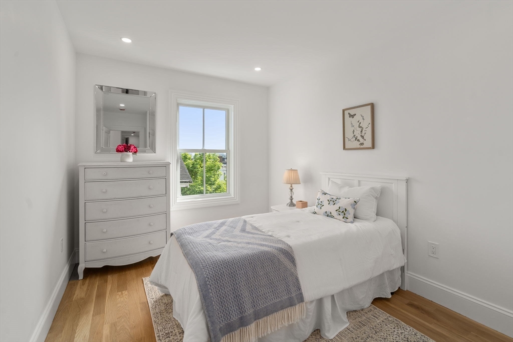 32 High Street Boston, MA 02129 - Photo 17 of 38 a bedroom with a bed and a dresser