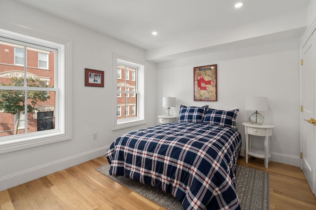 32 High Street Boston, MA 02129 - Photo 18 of 38 a bedroom with a bed and wooden floor