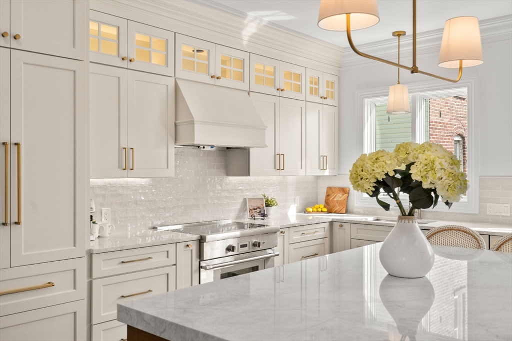 32 High Street Boston, MA 02129 - Photo 2 of 38 a kitchen with stainless steel appliances kitchen island granite countertop a sink a stove and a wooden floors
