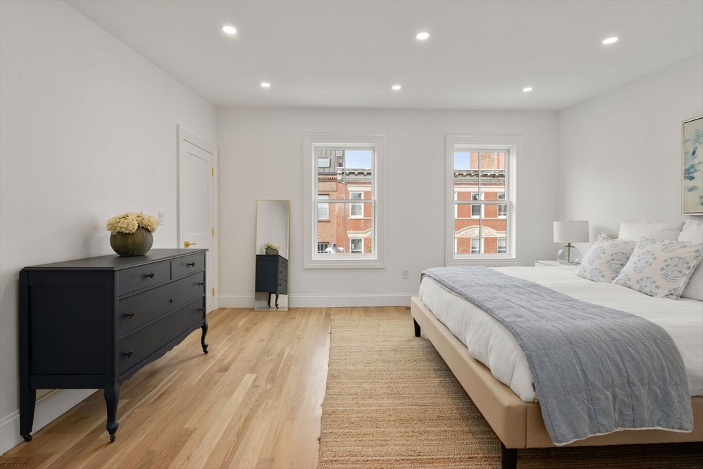 32 High Street Boston, MA 02129 - Photo 22 of 38 a spacious bedroom with a large bed and a window