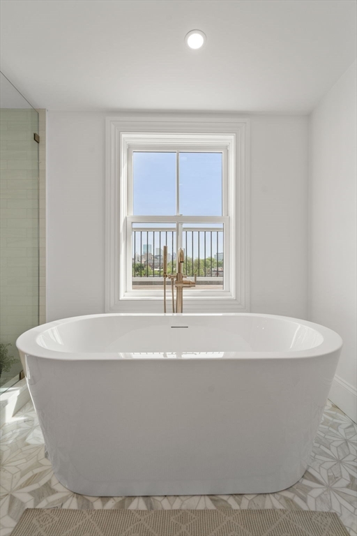 32 High Street Boston, MA 02129 - Photo 26 of 38 a white bath tub sitting in a bathroom