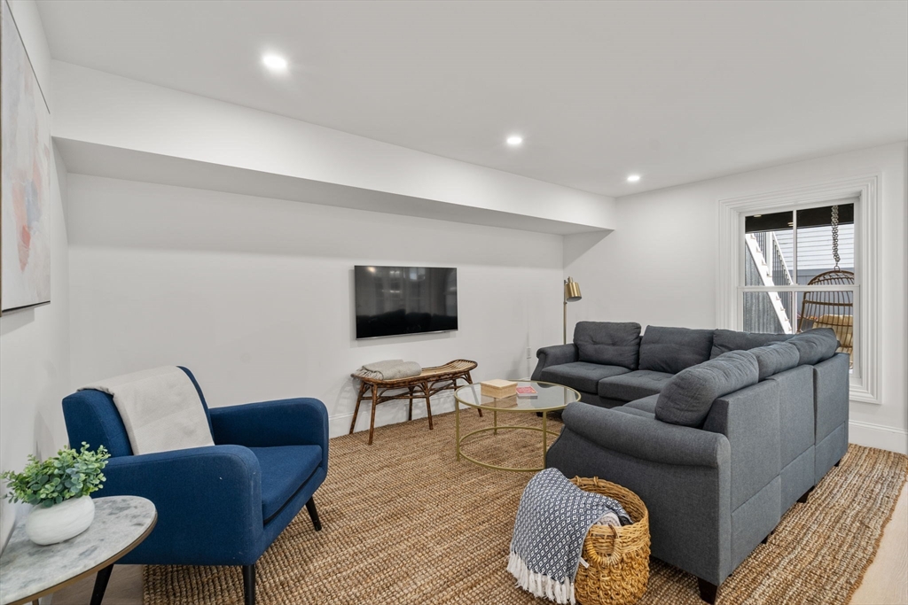 32 High Street Boston, MA 02129 - Photo 31 of 38 a living room with furniture and a flat screen tv