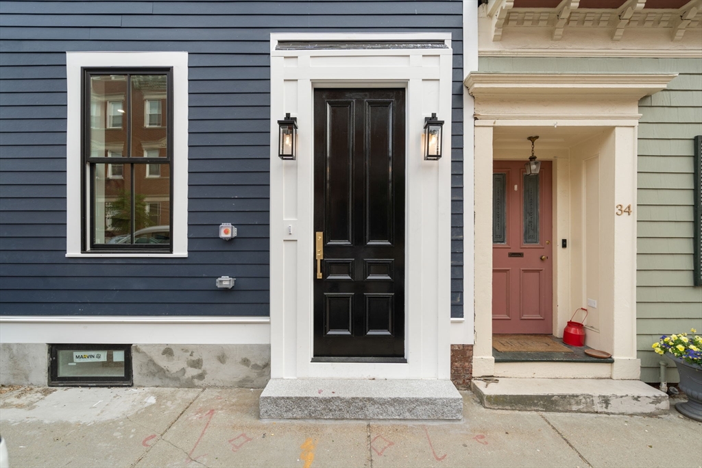 32 High Street Boston, MA 02129 - Photo 38 of 38 front view of a brick house with a door and a window