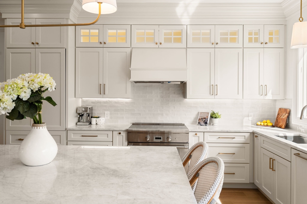 32 High Street Boston, MA 02129 - Photo 5 of 38 a kitchen with white cabinets and a stove