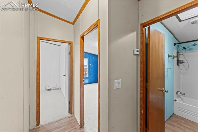 a view of a hallway with wooden floor and staircase
