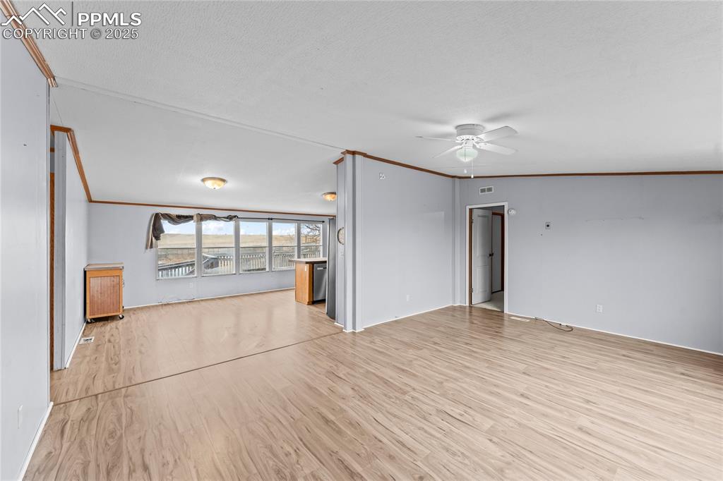 41275 Truckton Road Rush, CO 80833 - Photo 3 of 32 a view of empty room with wooden floor and fan