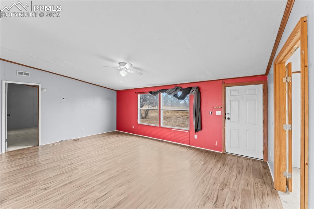 41275 Truckton Road Rush, CO 80833 - Photo 4 of 32 a view of an empty room with wooden floor and a window