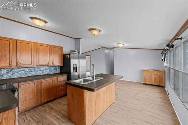 a kitchen with stainless steel appliances granite countertop a sink stove and wooden cabinets