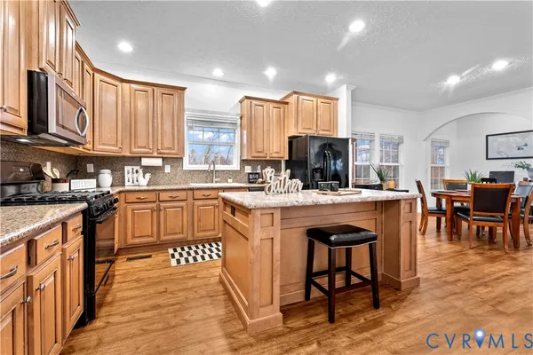 a kitchen with stainless steel appliances a sink and cabinets
