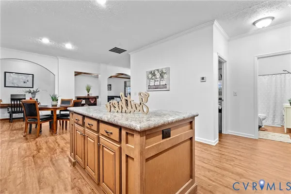 a kitchen with a table chairs refrigerator and microwave