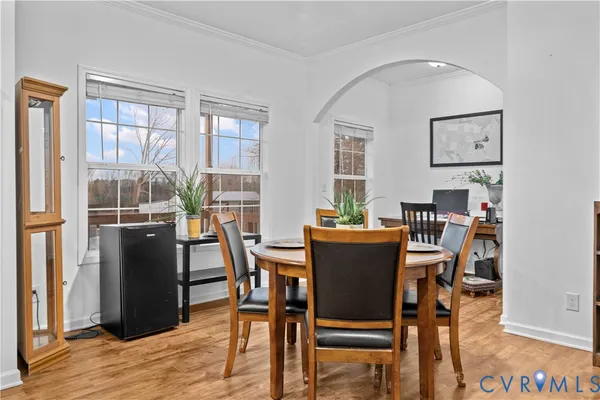 a dining room with furniture potted plant and kitchen view