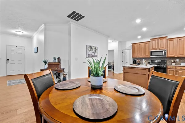 a view of a dining room with furniture and wooden floor