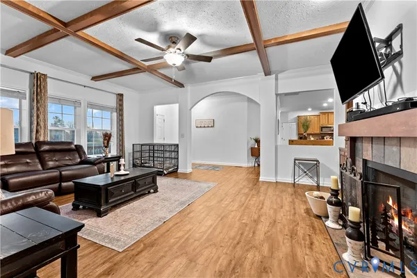 a living room with furniture fireplace and flat screen tv