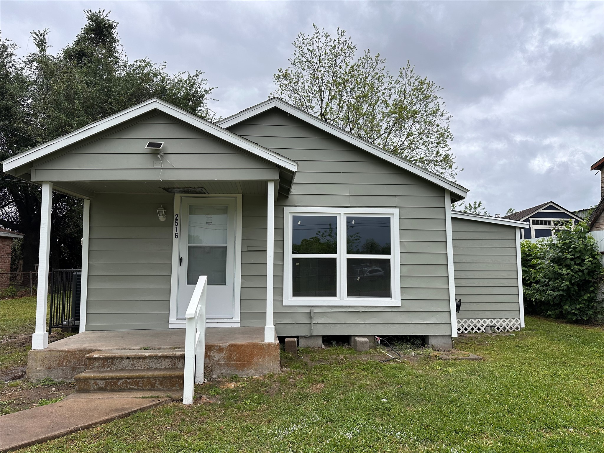2516 Ivy Street Houston, TX 77026 - Photo 1 of 9 a house with trees in the background