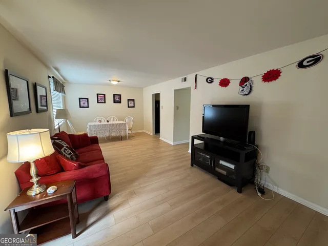 a living room with furniture and a flat screen tv