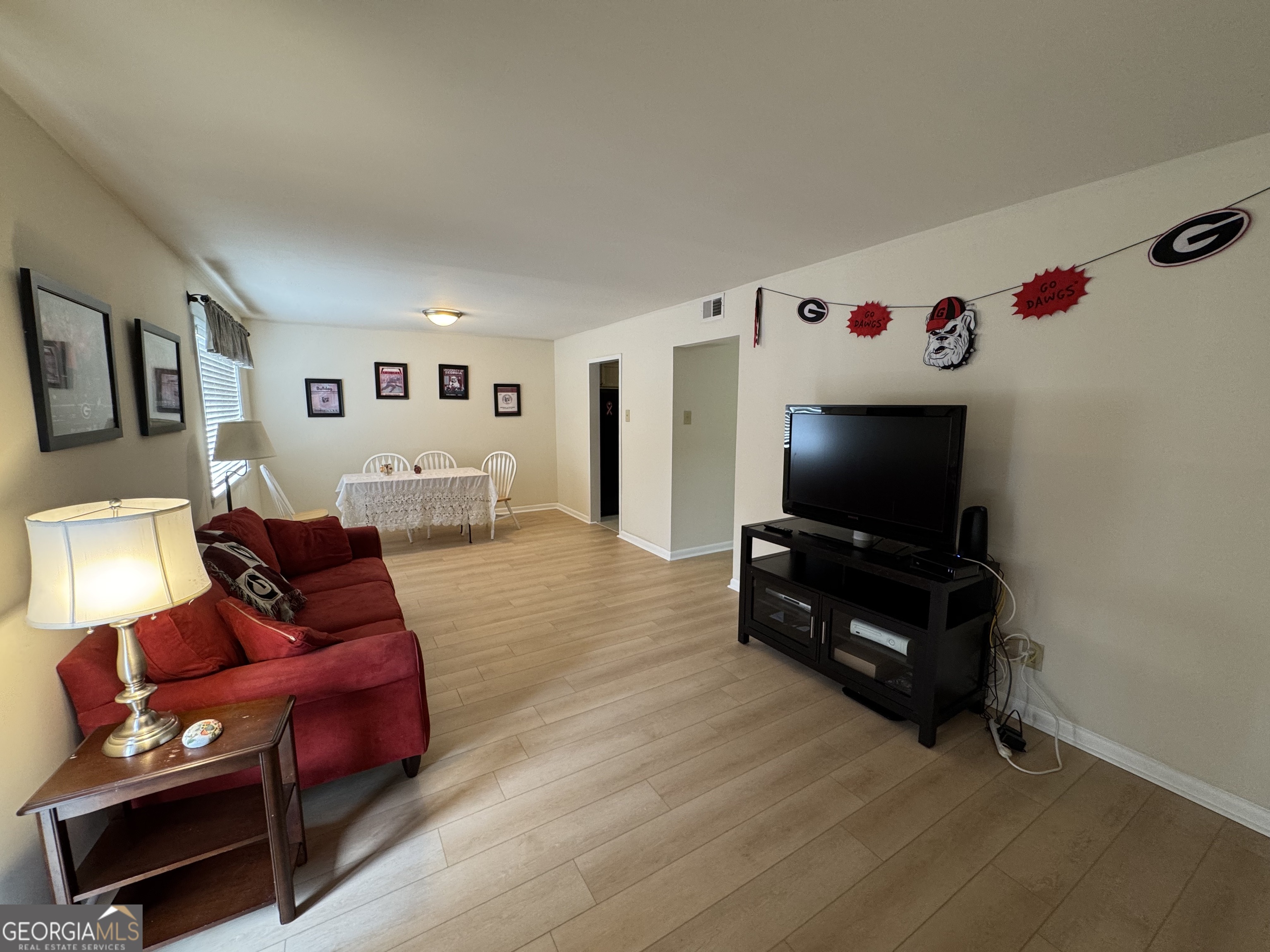 250 Little Street, Unit C210 Athens, GA 30605 - Photo 3 of 11 a living room with furniture and a flat screen tv