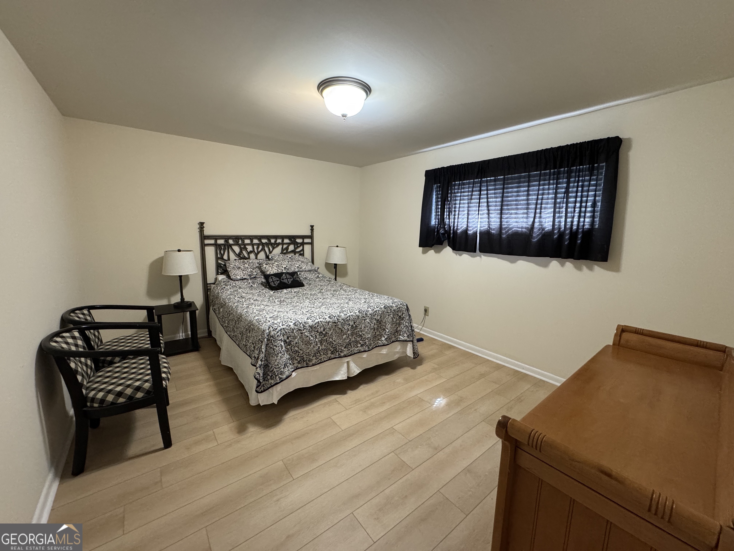 250 Little Street, Unit C210 Athens, GA 30605 - Photo 9 of 11 a bedroom with a bed and wooden floor
