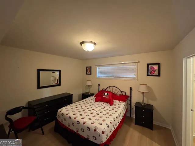 a bedroom with a bed and dresser in it