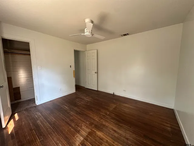 a view of hallway with wooden floor