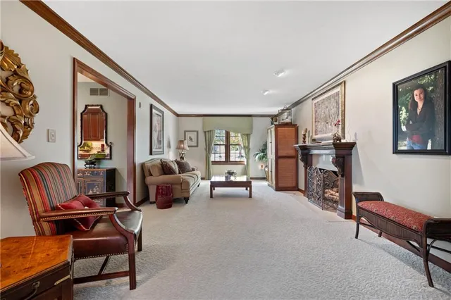 a living room with furniture and a flat screen tv with dresser