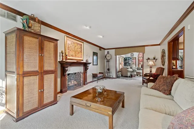 a living room with furniture a fireplace and a large window
