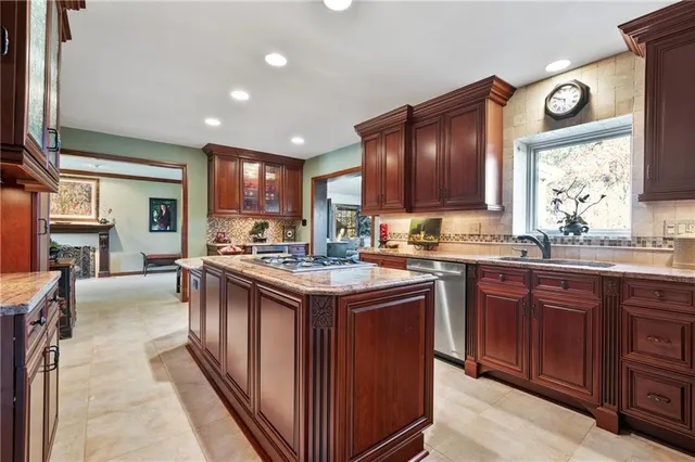 a kitchen with a stove top oven sink and cabinets