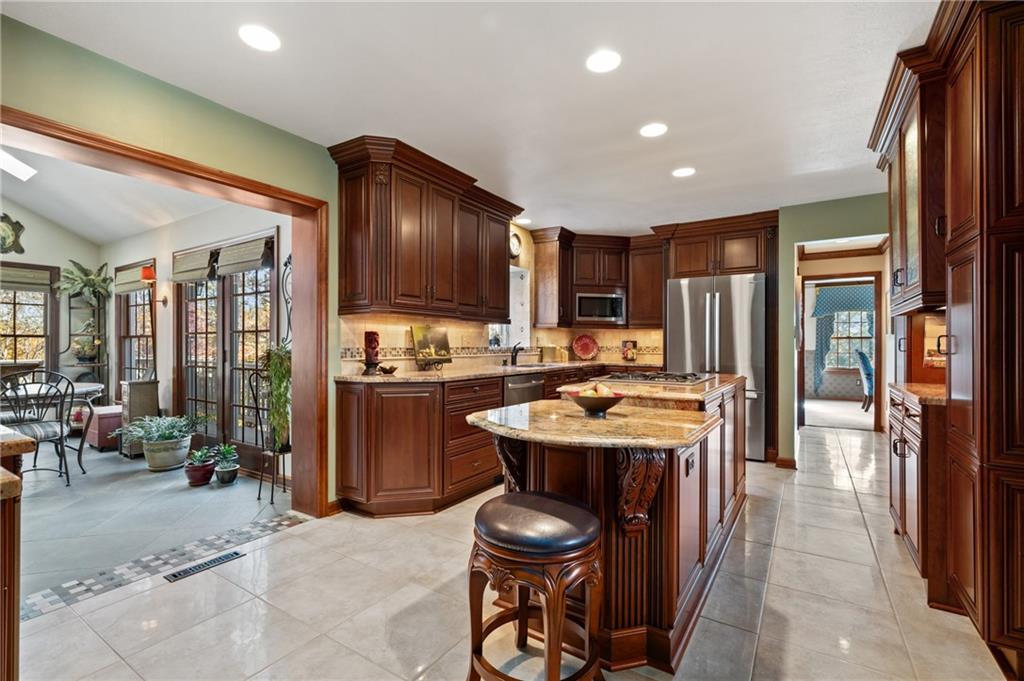 520 Colony Court Gibsonia, PA 15044 - Photo 15 of 45 a kitchen with a stove a refrigerator and a fireplace