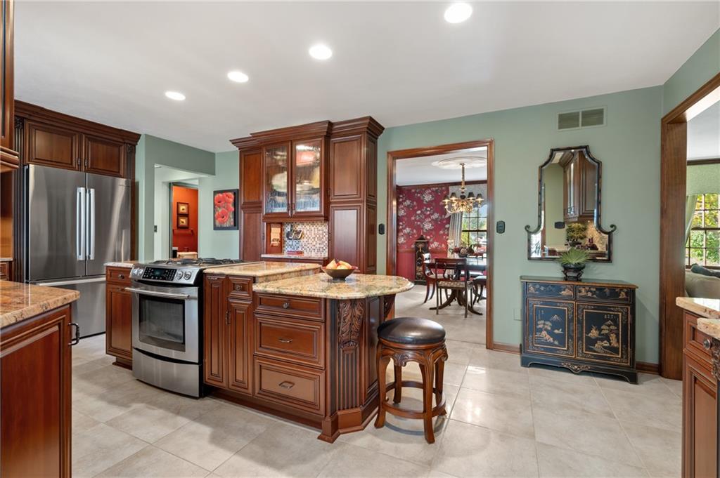 520 Colony Court Gibsonia, PA 15044 - Photo 16 of 45 a kitchen with stainless steel appliances granite countertop a stove and a refrigerator