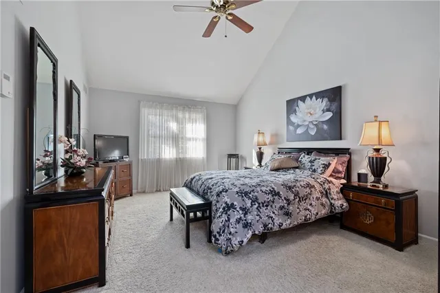 a bedroom with a bed and a dresser in it