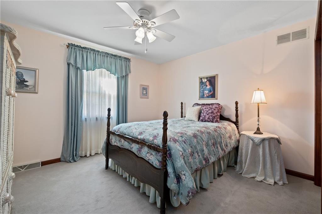 520 Colony Court Gibsonia, PA 15044 - Photo 32 of 45 a spacious bedroom with a bed and a chandelier
