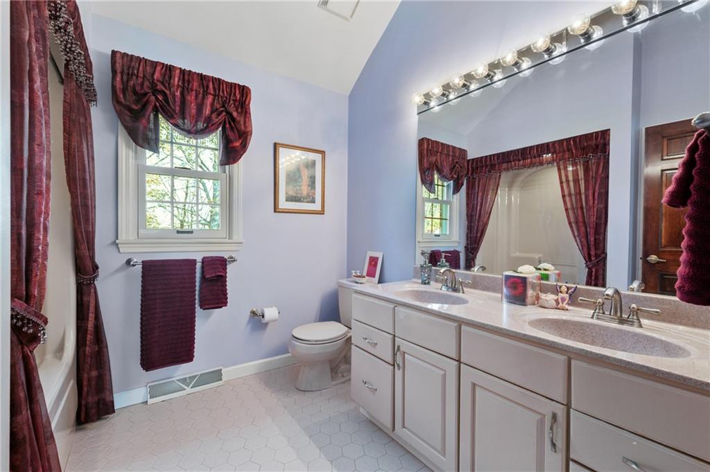 520 Colony Court Gibsonia, PA 15044 - Photo 33 of 45 a bathroom with a double vanity sink toilet mirror and window