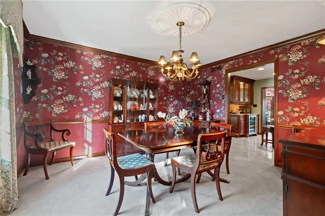 a dining room with furniture and chandelier