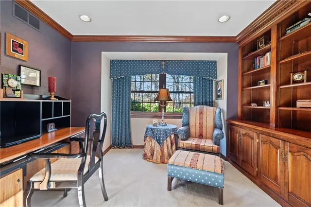 a living room with furniture and a book shelf