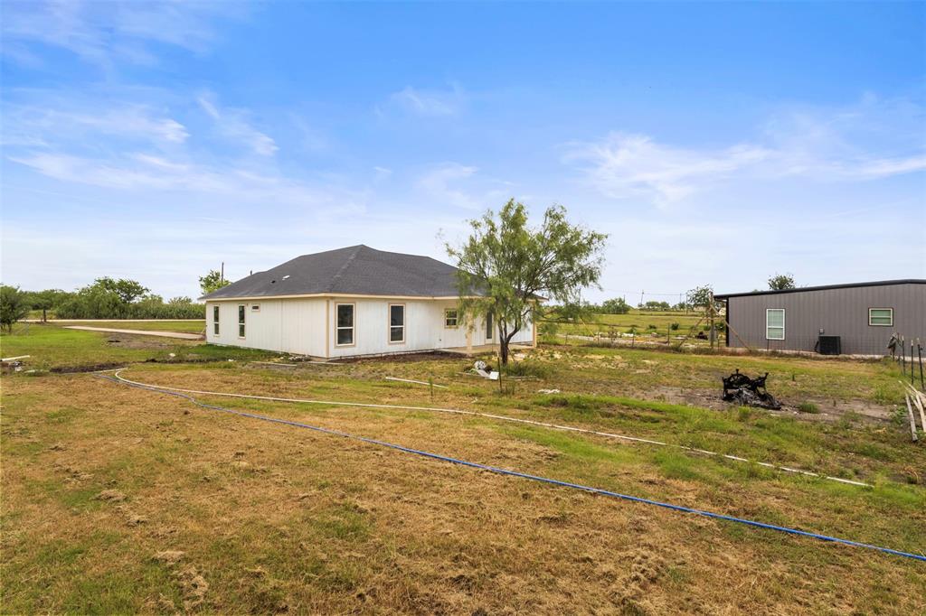 7074 Northeast County Road Rice, TX 75155 - Photo 16 of 22 a front view of a house with a yard