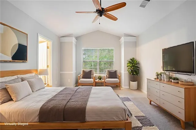 a bedroom with a large bed and flat tv screen on a dresser