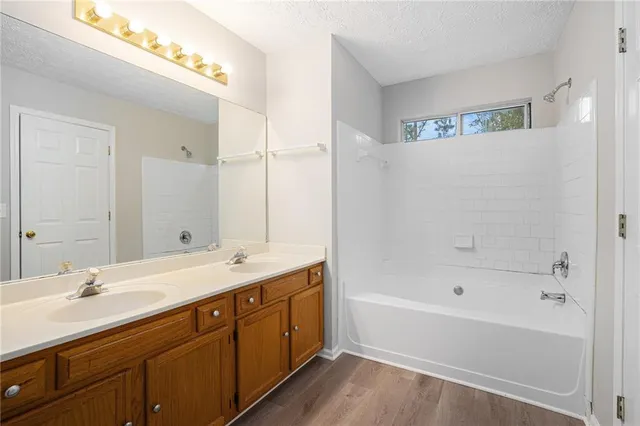 a bathroom with a tub sink and mirror