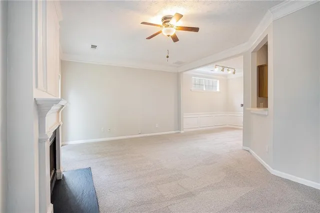 a view of an empty room with a ceiling fan