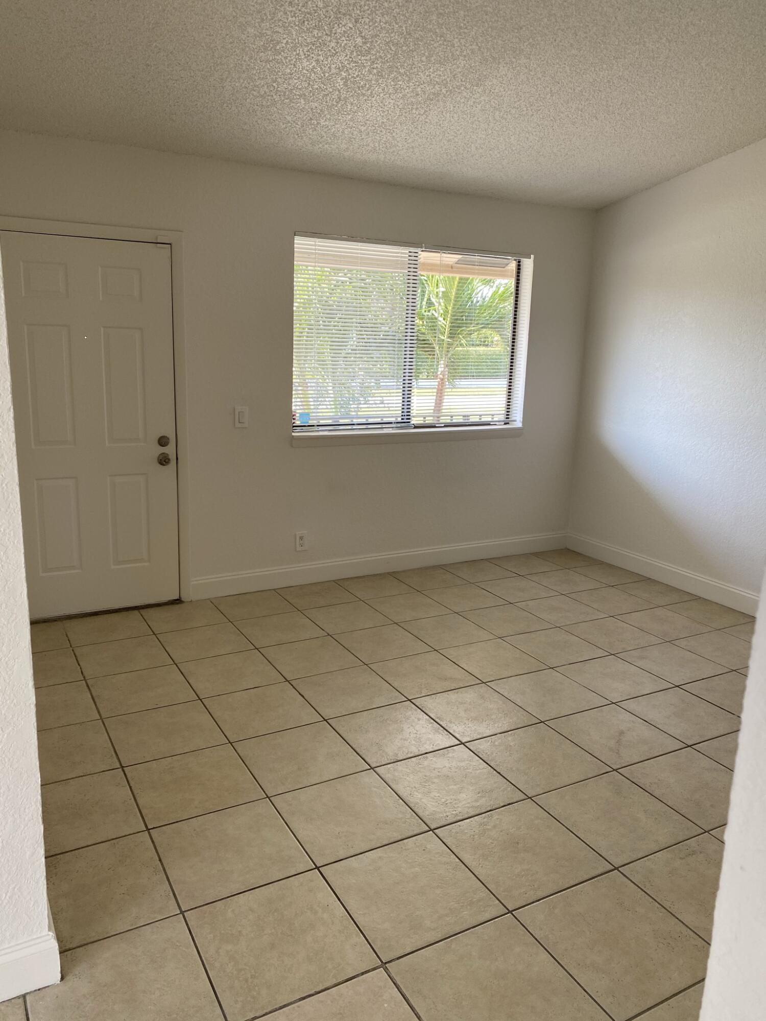 100 Nottingham Circle, Unit J Greenacres, FL 33463 - Photo 2 of 10 a view of an empty room and a window