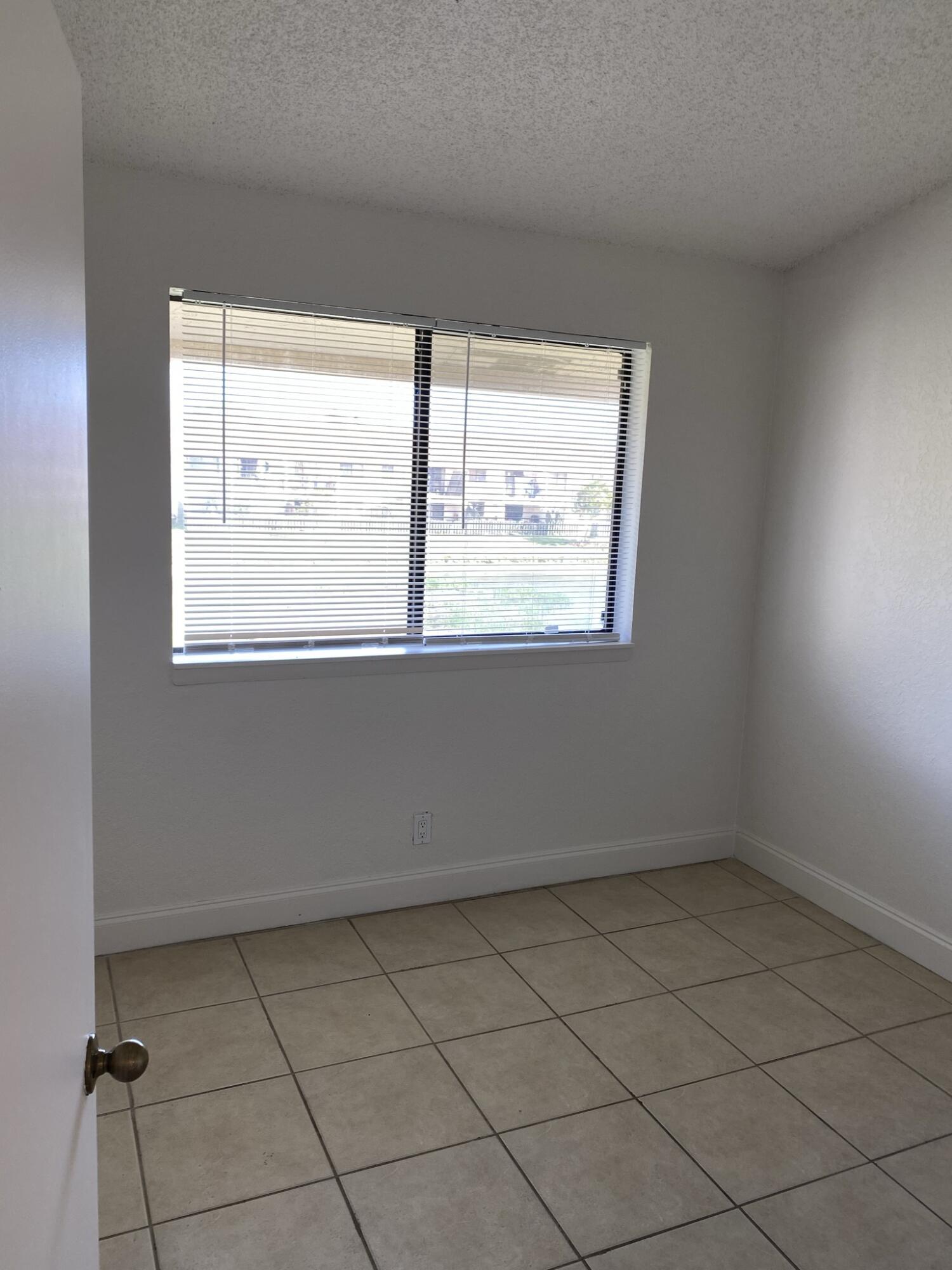 100 Nottingham Circle, Unit J Greenacres, FL 33463 - Photo 3 of 10 an empty room with a window
