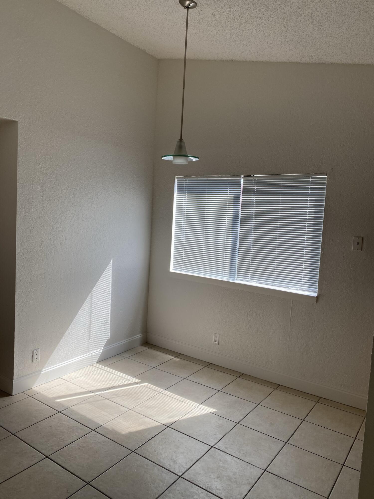 100 Nottingham Circle, Unit J Greenacres, FL 33463 - Photo 7 of 10 a view of an empty room with a window