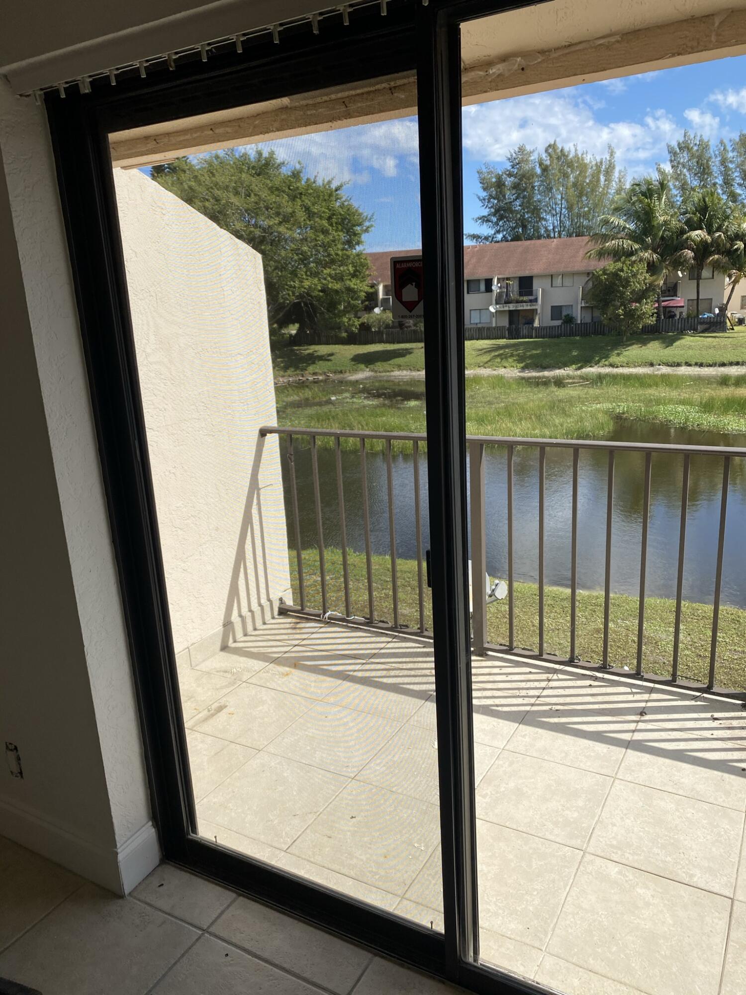100 Nottingham Circle, Unit J Greenacres, FL 33463 - Photo 9 of 10 a view of a porch