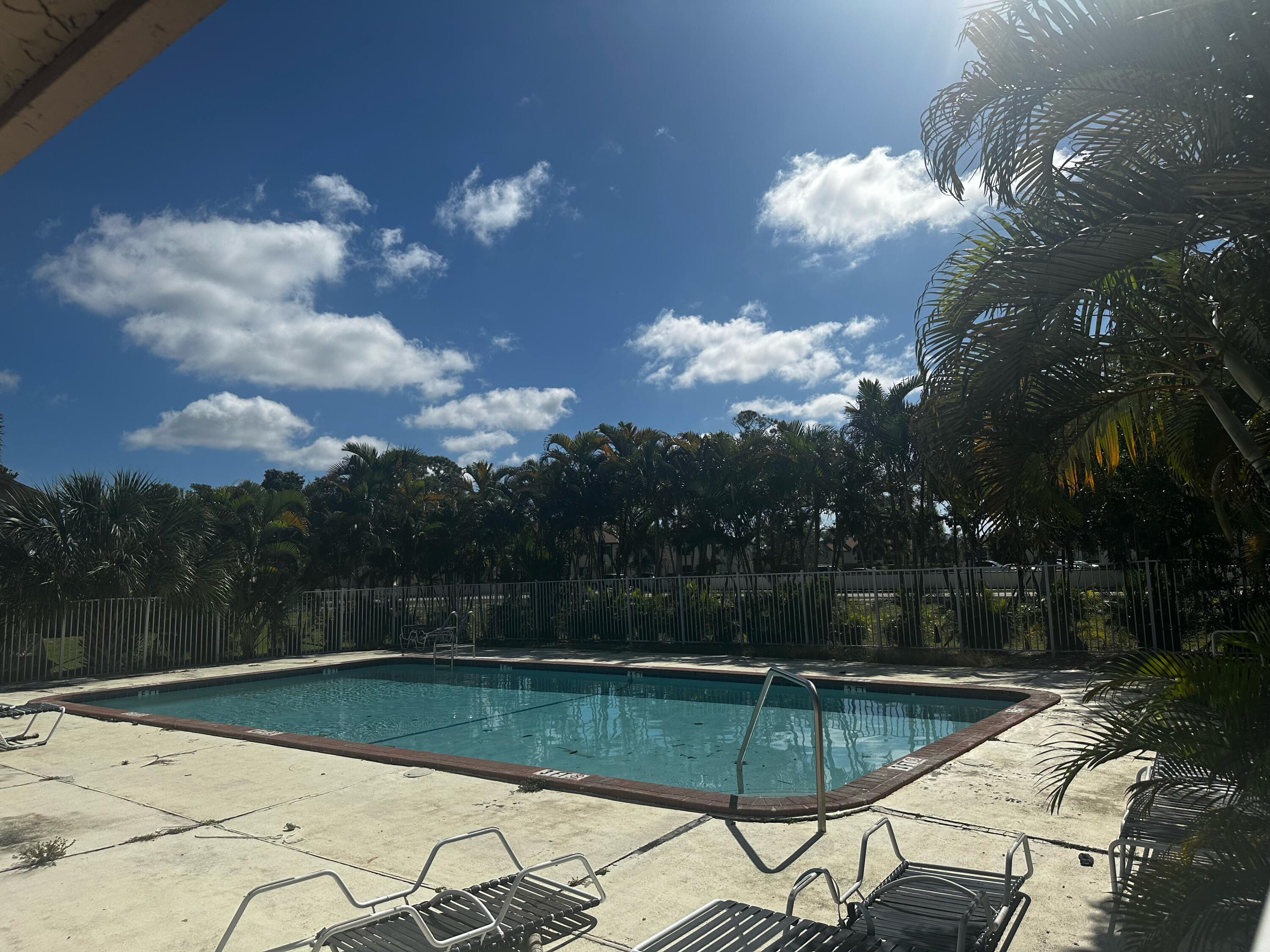 100 Nottingham Circle, Unit J Greenacres, FL 33463 - Photo 10 of 10 a view of a swimming pool with a patio