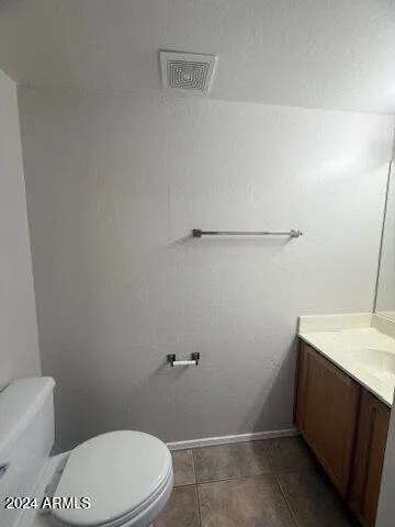 a white toilet sitting next to a bathroom sink