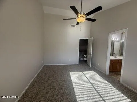 a view of a livingroom with a ceiling fan and wooden floor