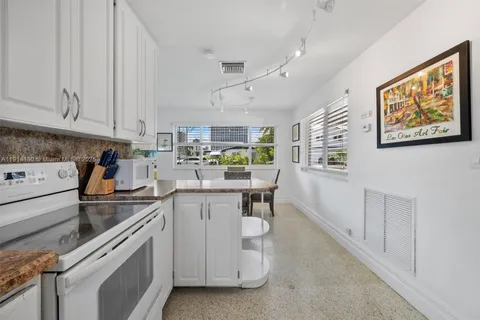 a kitchen with cabinets and window