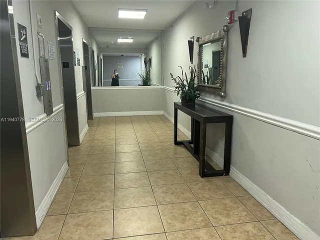 a lobby with furniture and a potted plant