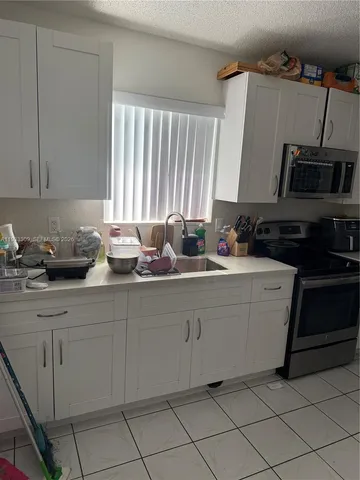 a view of a backyard with a fence